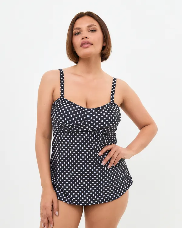 Woman wearing the Kate mastectomy tankini in black and white polka dot