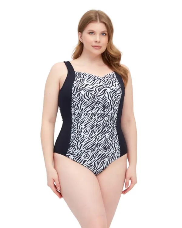 Woman wearing the Nadia swimsuit in black and white zebra print with black side panels